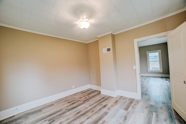 212 E Ash St, Watseka, IL 60970 - empty room featuring ornamental molding, light wood-type flooring, and baseboards
