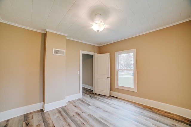 212 E Ash St, Watseka, IL 60970 - empty room with light wood finished floors, ornamental molding, and baseboards