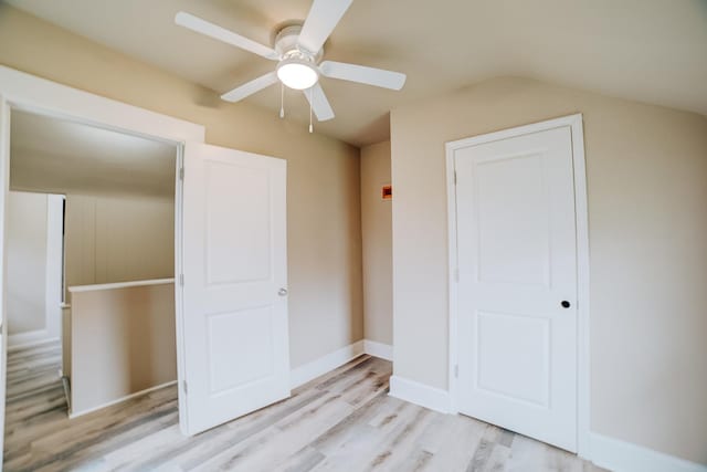 212 E Ash St, Watseka, IL 60970 - unfurnished bedroom with light wood-style floors, ceiling fan, lofted ceiling, a closet, and baseboards
