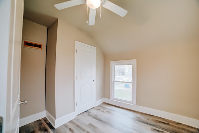 212 E Ash St, Watseka, IL 60970 - unfurnished bedroom with lofted ceiling, light wood finished floors, a ceiling fan, and baseboards