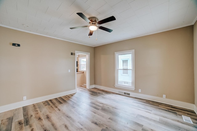 212 E Ash St, Watseka, IL 60970 - empty room featuring ornamental molding, a ceiling fan, light wood finished floors, and baseboards