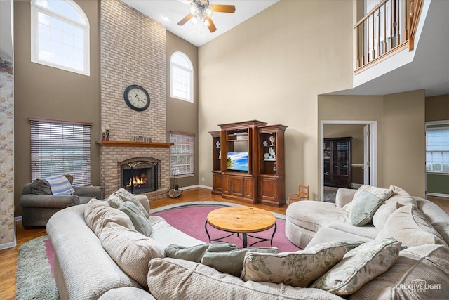 541 Clover Dr, Algonquin, IL 60102 - living room with a towering ceiling, ceiling fan, wood finished floors, a brick fireplace, and baseboards