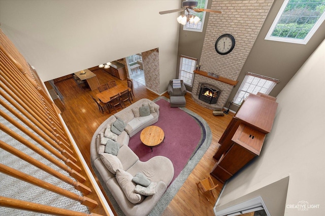 541 Clover Dr, Algonquin, IL 60102 - living room with a towering ceiling, a fireplace, wood finished floors, and a ceiling fan