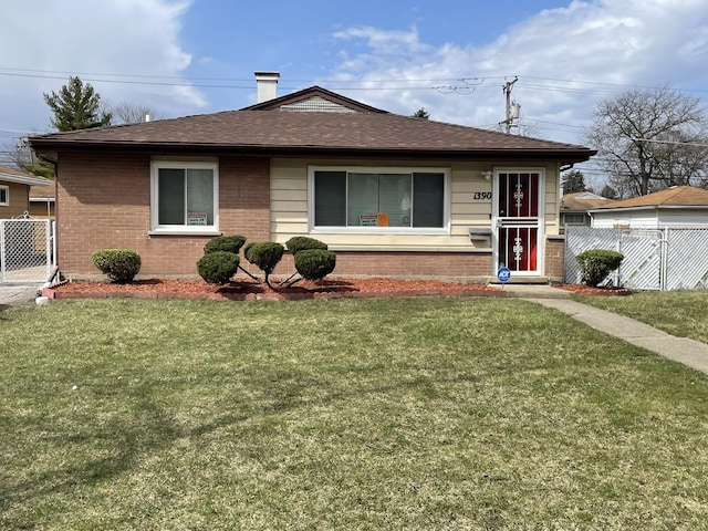 view of front of house with a front yard, brick siding, fence, and a shingled roof