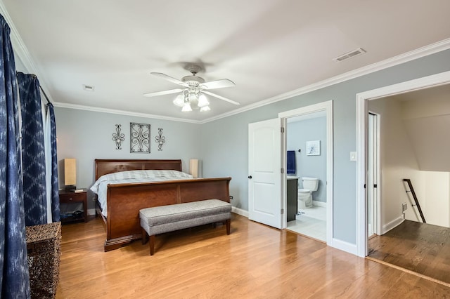 bedroom featuring ornamental molding, visible vents, baseboards, and wood finished floors