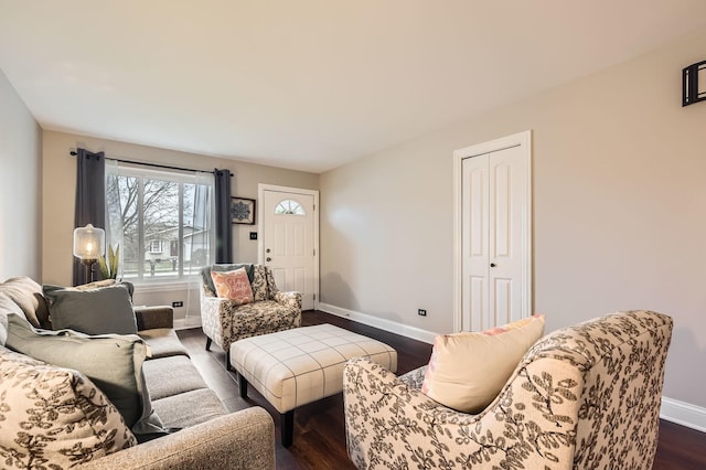 living room featuring baseboards and dark wood finished floors