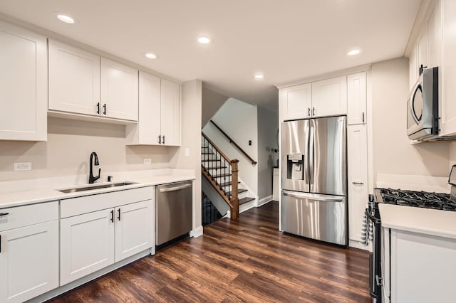 kitchen featuring a sink, white cabinetry, dark wood-type flooring, and stainless steel appliances
