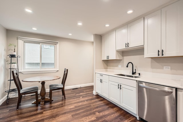 kitchen with dishwasher, a sink, dark wood-style flooring, light countertops, and recessed lighting
