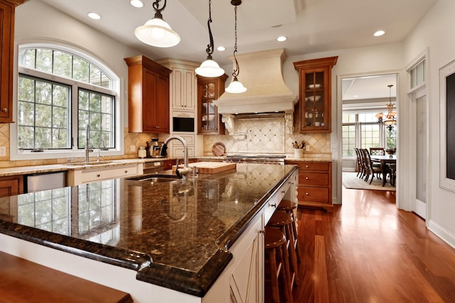 3131 Pepper Creek Bridge Pkwy, Valparaiso, IN 46385 - kitchen featuring custom range hood, dark wood-style flooring, recessed lighting, backsplash, and glass insert cabinets