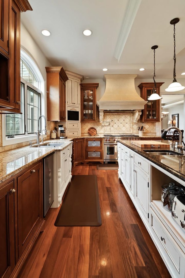 3131 Pepper Creek Bridge Pkwy, Valparaiso, IN 46385 - kitchen featuring custom range hood, high end stainless steel range, light stone counters, glass insert cabinets, and recessed lighting