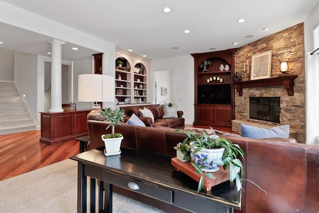 3131 Pepper Creek Bridge Pkwy, Valparaiso, IN 46385 - living area featuring recessed lighting, built in features, decorative columns, wood finished floors, and a stone fireplace