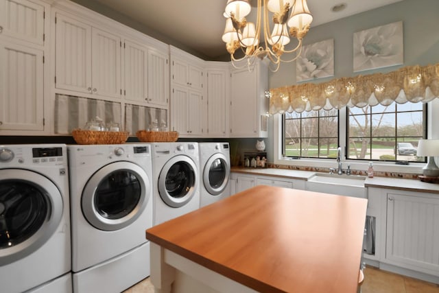 3131 Pepper Creek Bridge Pkwy, Valparaiso, IN 46385 - laundry area with independent washer and dryer, cabinet space, a chandelier, and light tile patterned floors