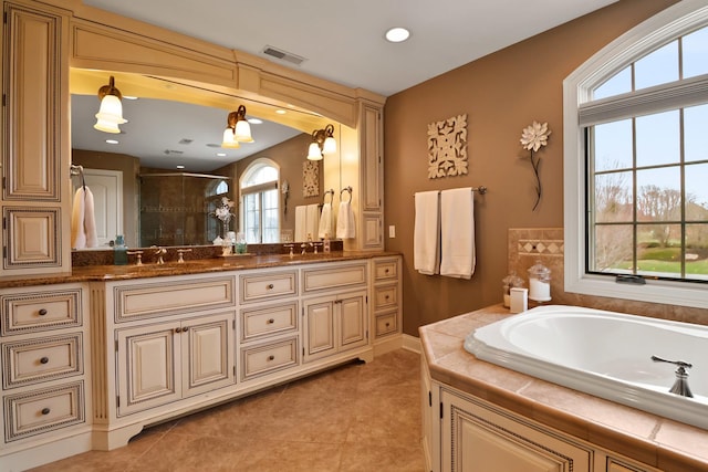 3131 Pepper Creek Bridge Pkwy, Valparaiso, IN 46385 - bathroom featuring double vanity, a shower stall, a bath, tile patterned floors, and recessed lighting