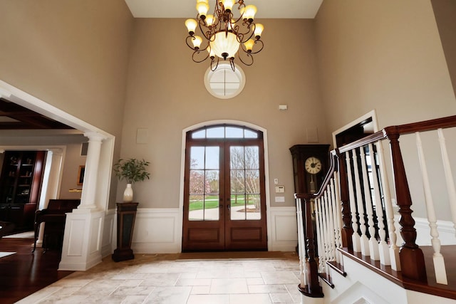 3131 Pepper Creek Bridge Pkwy, Valparaiso, IN 46385 - foyer with a towering ceiling, a chandelier, a wainscoted wall, french doors, and stairs