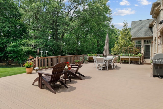 3131 Pepper Creek Bridge Pkwy, Valparaiso, IN 46385 - deck with outdoor dining area, grilling area, and view of wooded area