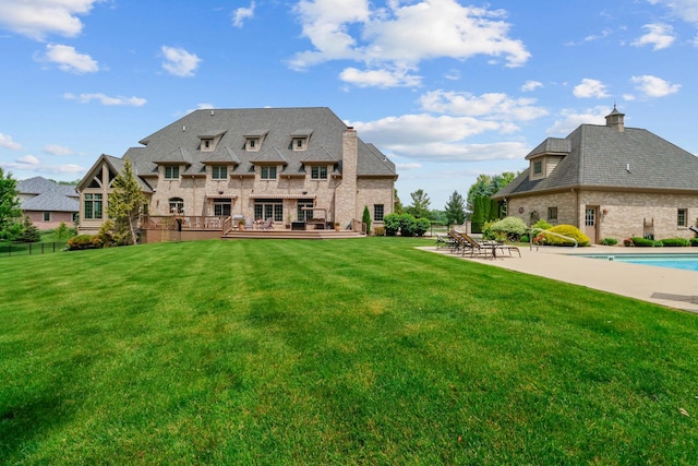 3131 Pepper Creek Bridge Pkwy, Valparaiso, IN 46385 - rear view of property featuring a chimney, a deck, stone siding, a patio, and brick siding