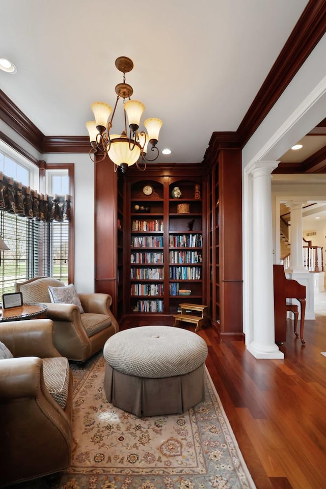 3131 Pepper Creek Bridge Pkwy, Valparaiso, IN 46385 - sitting room with decorative columns, a chandelier, crown molding, wood finished floors, and built in shelves