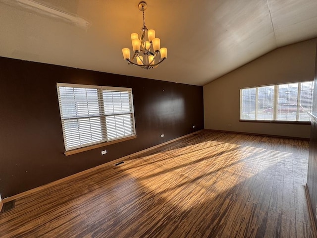 16426 Homan Ave, Markham, IL 60428 - spare room featuring an inviting chandelier, visible vents, vaulted ceiling, hardwood / wood-style floors, and baseboards