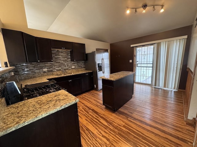 16426 Homan Ave, Markham, IL 60428 - kitchen with a center island, stainless steel fridge, a sink, wood finished floors, and backsplash