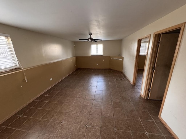 16426 Homan Ave, Markham, IL 60428 - empty room featuring dark tile patterned flooring, ceiling fan, and baseboards