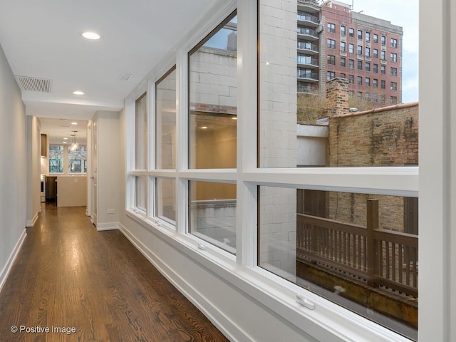 hallway featuring visible vents, recessed lighting, dark wood-style floors, and baseboards