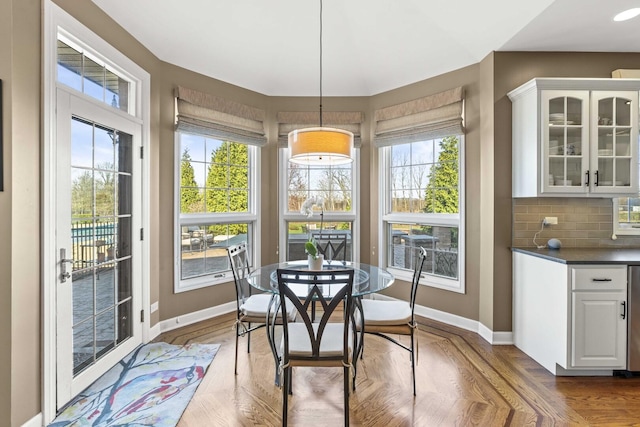 dining space featuring wood finished floors and baseboards