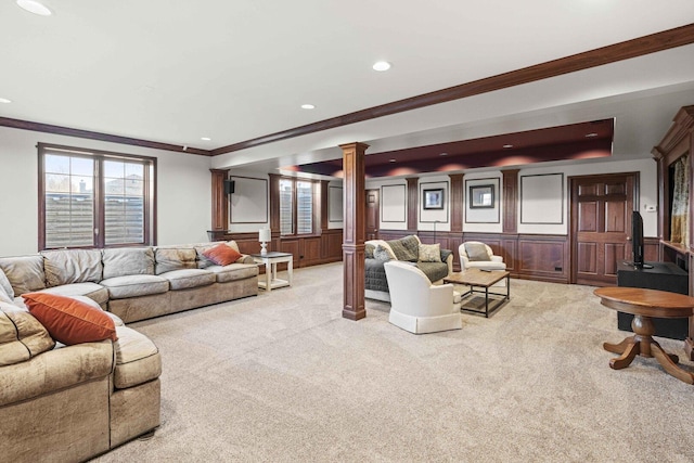 living area with crown molding, ornate columns, light colored carpet, and recessed lighting