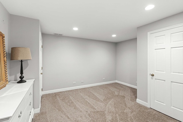 unfurnished bedroom featuring visible vents, baseboards, recessed lighting, and light carpet