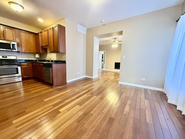 4731 S Ingleside Ave Unit C3, Chicago, IL 60615 - kitchen with light wood-type flooring, dark countertops, open floor plan, visible vents, and appliances with stainless steel finishes
