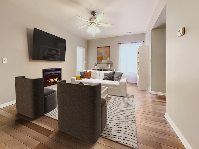 4731 S Ingleside Ave Unit C3, Chicago, IL 60615 - living area featuring baseboards, a ceiling fan, a lit fireplace, and hardwood / wood-style floors