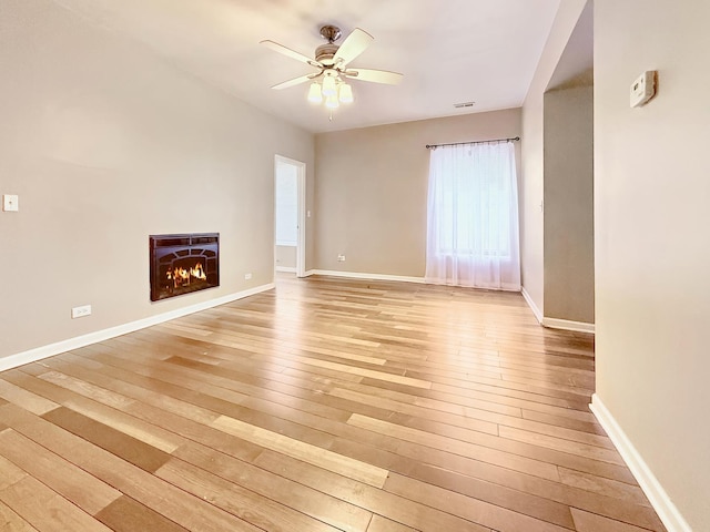 4731 S Ingleside Ave Unit C3, Chicago, IL 60615 - unfurnished living room with a warm lit fireplace, light wood-type flooring, baseboards, and ceiling fan