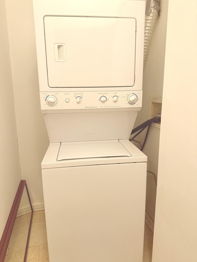 4731 S Ingleside Ave Unit C3, Chicago, IL 60615 - laundry room with baseboards, stacked washer and clothes dryer, laundry area, and light tile patterned floors