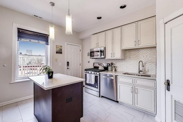 834 W Belle Plaine Ave Unit 3W, Chicago, IL 60613 - kitchen featuring visible vents, a sink, light countertops, appliances with stainless steel finishes, and decorative backsplash