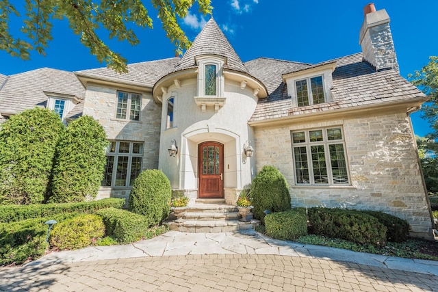 96 S Wynstone Dr, North Barrington, IL 60010 - french country inspired facade with a high end roof, a chimney, and stone siding