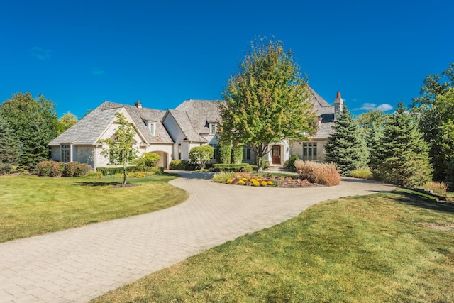 96 S Wynstone Dr, North Barrington, IL 60010 - view of front facade with curved driveway, a chimney, and a front lawn
