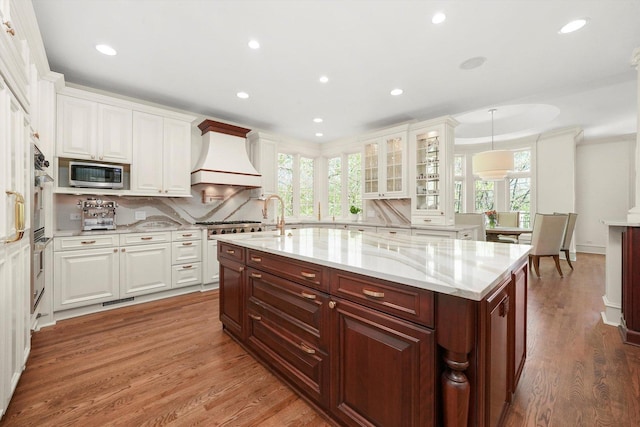 96 S Wynstone Dr, North Barrington, IL 60010 - kitchen with appliances with stainless steel finishes, white cabinetry, custom range hood, tasteful backsplash, and recessed lighting