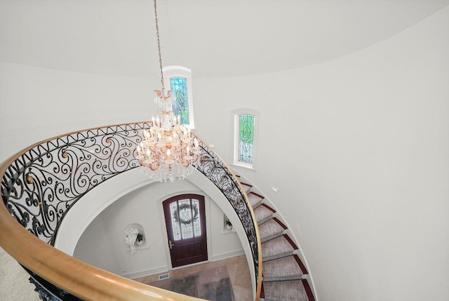 96 S Wynstone Dr, North Barrington, IL 60010 - staircase featuring a chandelier, plenty of natural light, a high ceiling, and arched walkways