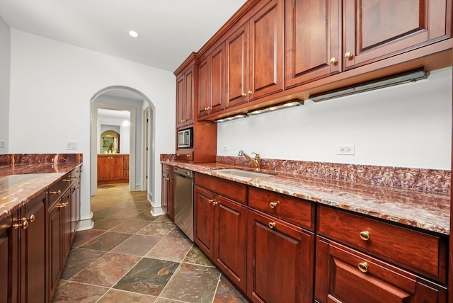96 S Wynstone Dr, North Barrington, IL 60010 - kitchen featuring appliances with stainless steel finishes, arched walkways, dark stone countertops, dark stone finish flooring, and recessed lighting