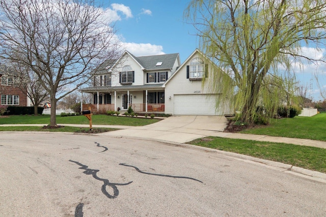 traditional-style house with a porch, an attached garage, driveway, and a front lawn