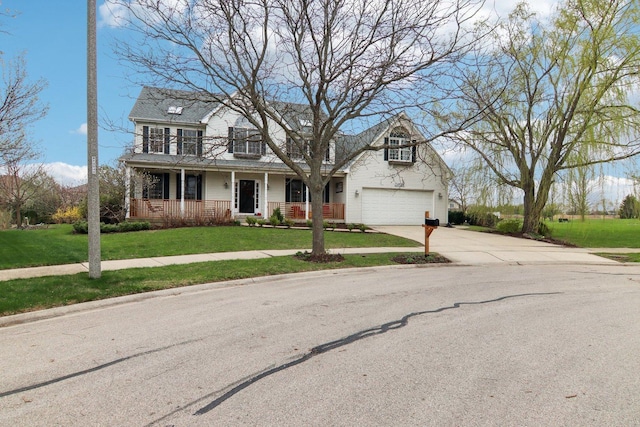 traditional-style home featuring covered porch, an attached garage, concrete driveway, and a front yard