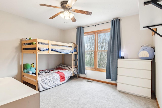 carpeted bedroom featuring visible vents, a ceiling fan, and baseboards