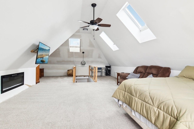 carpeted bedroom featuring ceiling fan and vaulted ceiling with skylight
