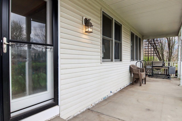 view of side of property featuring covered porch