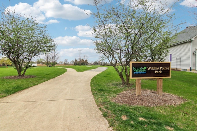view of home's community with a yard