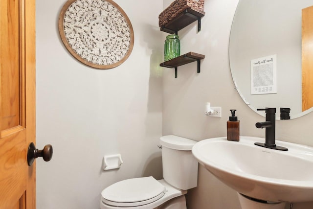 bathroom with toilet and a sink