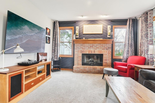 carpeted living area with wooden walls, baseboards, plenty of natural light, and a fireplace