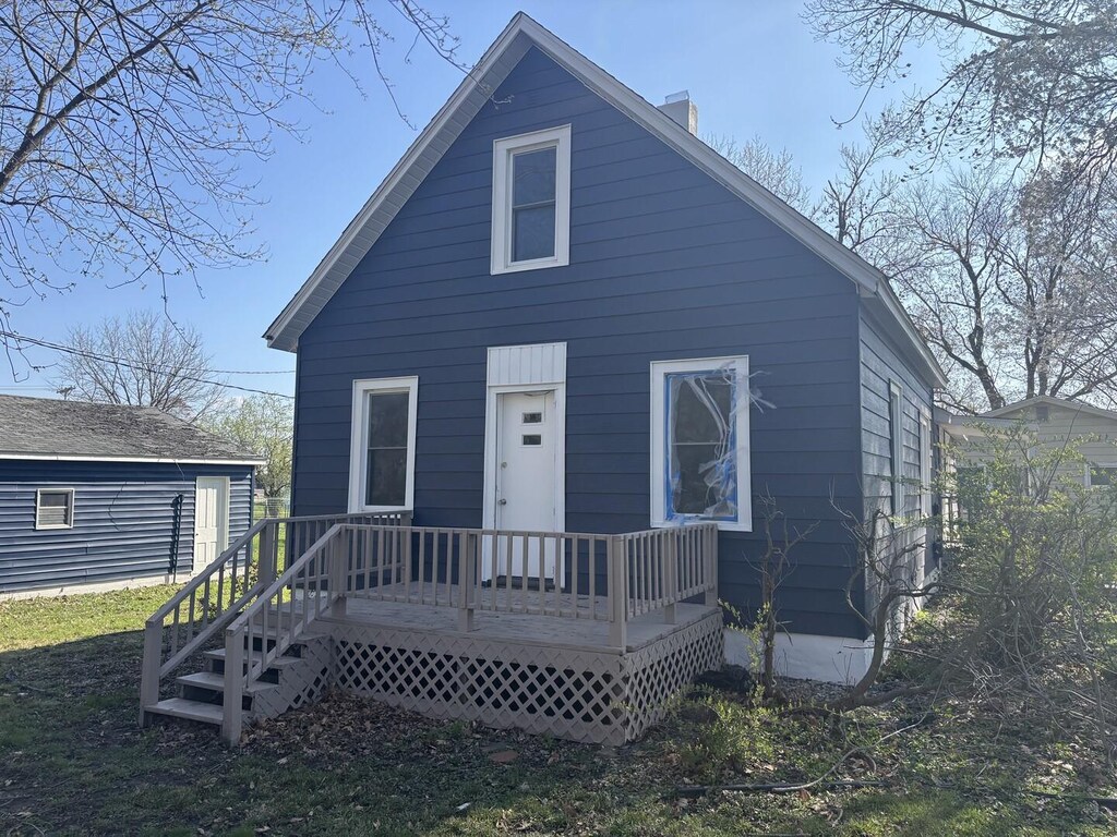 view of front of property featuring a chimney and a deck