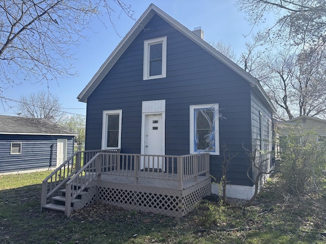 view of front of property featuring a chimney and a deck