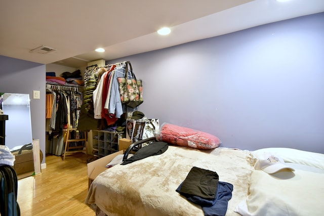 bedroom featuring recessed lighting, visible vents, a closet, and wood finished floors
