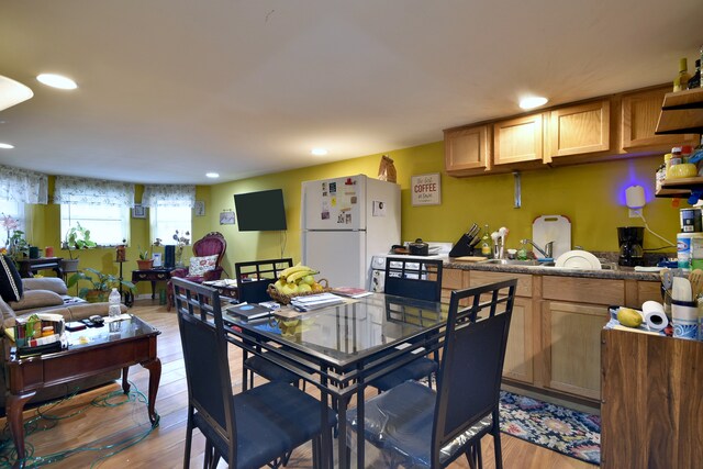 dining area with light wood-type flooring and recessed lighting